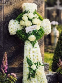 Celtic cross funeral flowers in with white and green flowers